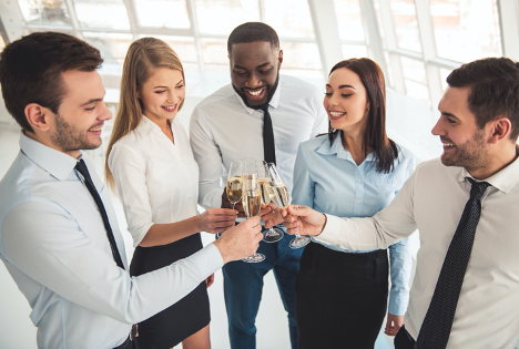 Team members celebrating corporate christmas together with champagne. 